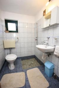 a bathroom with a toilet and a sink at Seaside house for families with children Cove Soline, Pasman - 8482 in Kraj