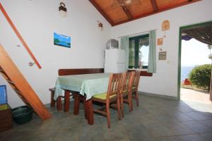 a dining room with a table and chairs and the ocean at Seaside house for families with children Cove Soline, Pasman - 8482 in Kraj +23 photos
