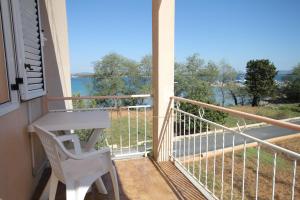 a balcony with a table and a view of the water at Double Room Tkon 8377d in Tkon