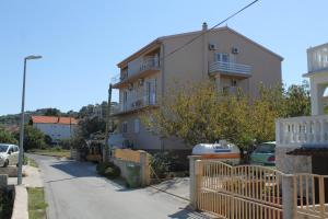 a building with a fence next to a street at Double Room Tkon 8377c in Tkon