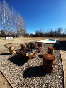 a group of logs sitting on top of a field at Casa Julia, Tunuyán in Colonia Las Rosas