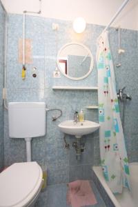 a bathroom with a toilet and a sink at Apartments by the sea Duce, Omis - 8633 in Omiš