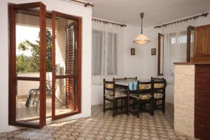 a kitchen and dining room with a table and chairs at Apartments by the sea Zdrelac, Pasman - 8285 in Ždrelac