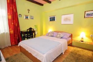 a bedroom with a bed and a table with a chair at Seaside house with a swimming pool Mokosica, Dubrovnik - 8583 in Mokošica +36 photos