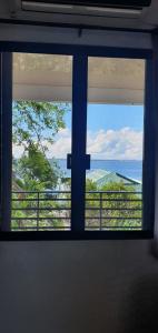 a view of the ocean from a window at Lola's Guest House in Mactan