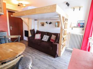 a living room with a couch and a loft bed at Studio Tignes, 1 pièce, 2 personnes - FR-1-502-439 in Tignes