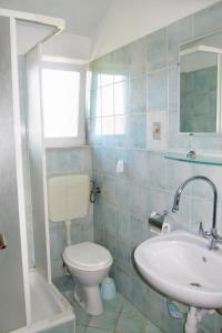 a bathroom with a toilet and a sink at Apartments by the sea Luka, Dugi otok - 8182 in Luka