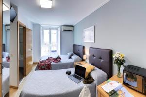Postel nebo postele na pokoji v ubytování Hostal Patria Madrid