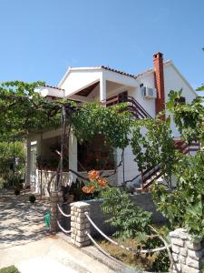 a house with a hose in front of it at Apartments with parking space Kraj, Pasman - 8372 in Tkon