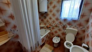 a bathroom with a toilet and a sink and a window at Apartments with parking space Kraj, Pasman - 8372 in Tkon +21 photos