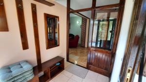 a hallway with a wooden door and a mirror at Apartments with a parking space Kraj, Pasman - 8372 in Tkon
