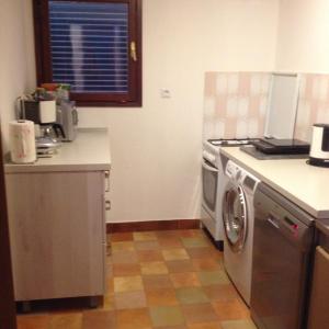 a kitchen with a stove and a washing machine at Apartments by the sea Molunat, Dubrovnik - 8550 in Molunat
