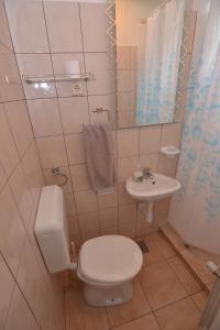a bathroom with a toilet and a sink at Apartments by the sea Tkon, Pasman - 8455 in Tkon +23 photos