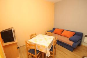 a small living room with a couch and a table at Apartments by the sea Mrljane, Pasman - 8463 in Neviđane
