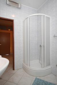 a bathroom with a shower with a glass door at Apartments by the sea Mrljane, Pasman - 8463 in Neviđane +21 photos