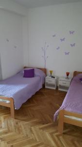 a bedroom with two beds and two night stands at Apartments and rooms by the sea Mrljane, Pasman - 8464 in Neviđane