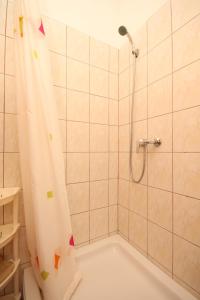 a bathroom with a shower with a shower curtain at Studio Susica 8265a in Ugljan