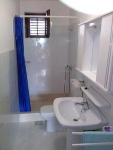 a white bathroom with a sink and a toilet at Apartments by the sea Lukoran (Ugljan) - 8494 in Lukoran +21 photos