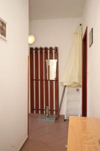a room with a wooden fence in a room at Apartments with a parking space Ugljan - 8493 in Ugljan