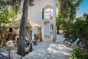 ein Fahrrad, das vor einem Gebäude mit Bäumen geparkt ist in der Unterkunft Seaside holiday house Okrug Gornji, Ciovo - 8645 in Trogir