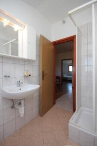 a bathroom with a sink and a bath tub at Apartments by the sea Dobropoljana, Pasman - 8198 in Dobropoljana