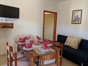 a dining room table with red napkins on it at Apartments by the sea Dobropoljana, Pasman - 8198 in Dobropoljana