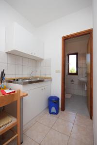 a kitchen with a counter and a sink and a toilet at Apartments by the sea Dobropoljana, Pasman - 8198 in Dobropoljana
