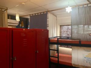 a room with red lockers and a room with a bed at Moon Fools Hostel in Panglao