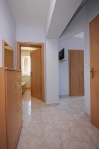an empty room with wooden cabinets and a hallway at Apartments by the sea Kali, Ugljan - 8235 in Kali