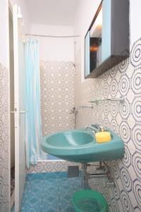 a bathroom with a blue sink and a mirror at Apartments by the sea Kali, Ugljan - 8270 in Kali