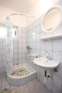 a white bathroom with a sink and a mirror at Apartments by the sea Ugljan - 8519 in Ugljan