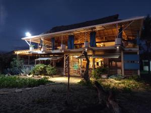 a house at night with the lights on at Sirena Surf Lodge Miramar Nicaragua in Miramar