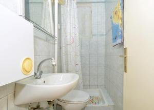 a bathroom with a sink and a toilet at Apartments by the sea Arbanija, Ciovo - 8651 in Trogir