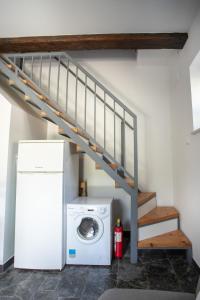 a laundry room with a staircase and a washing machine at Family friendly seaside apartments Duce, Omis - 8668 in Duće