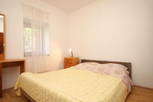 a bedroom with a bed and a window at Apartments by the sea Lukoran (Ugljan) - 8510 in Lukoran