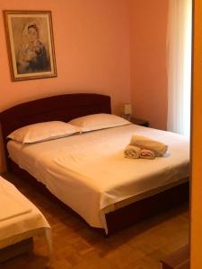 a bedroom with a bed with two towels on it at Apartments by the sea Duce, Omis - 8680 in Duće