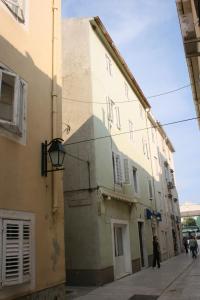 a building on the side of a street at Apartments by the sea Pag - 6475 in Pag
