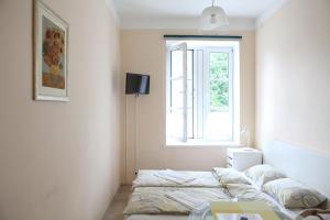 a bedroom with a bed and a window at Sea&Sand apartments in Juodkrantė