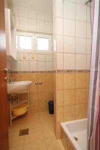 a small bathroom with a sink and a tub at Apartments by the sea Cove Pokrivenik, Hvar - 8673 in Zastražišće