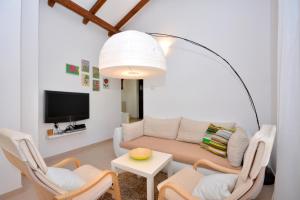 a living room with a couch and chairs and a tv at Holiday house with a swimming pool Basina, Hvar - 8731 in Vrbanj
