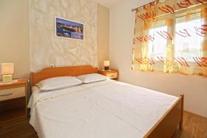 Schlafzimmer mit einem großen weißen Bett und einem Fenster in der Unterkunft Apartments by the sea Cove Zarace - Dubovica, Hvar - 8778 in Zarače