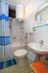 ein Badezimmer mit einem WC, einem Waschbecken und einem Spiegel in der Unterkunft Apartments by the sea Cove Zarace - Dubovica, Hvar - 8778 in Zarače