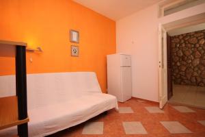 a small room with a bed and a refrigerator at Apartment Sveta Nedilja 8725c in Sveta Nedelja