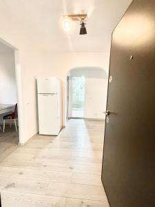 an empty room with a refrigerator and a hallway at Apartment modern in Sulina in Sulina