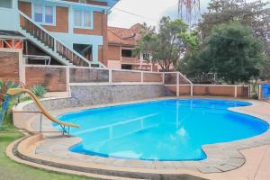 a swimming pool in the backyard of a house at Urbanview Hotel Syariah Insani Cisarua Puncak in Bogor