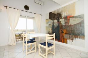 a dining room with a table and chairs and a painting at Apartments with a parking space Hvar - 8791 in Hvar