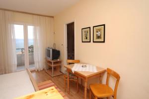 a dining room with a table and a television at Apartments and rooms with parking space Jelsa, Hvar - 8798 in Jelsa