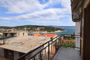 a balcony of a building with a view of the ocean at Apartments and rooms with parking space Jelsa, Hvar - 8798 in Jelsa