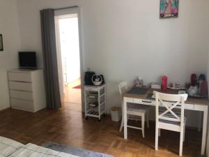 a room with a desk with a computer and chairs at Villa Reder in Bad Sauerbrunn