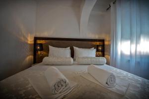 a bedroom with a large bed with towels on it at Apartment Zecevo Rtic 8366d in Rogoznica